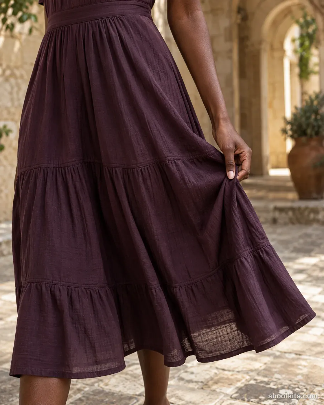 Fabric detail: dress photo made with ChatGPT. Shaded heritage courtyard.